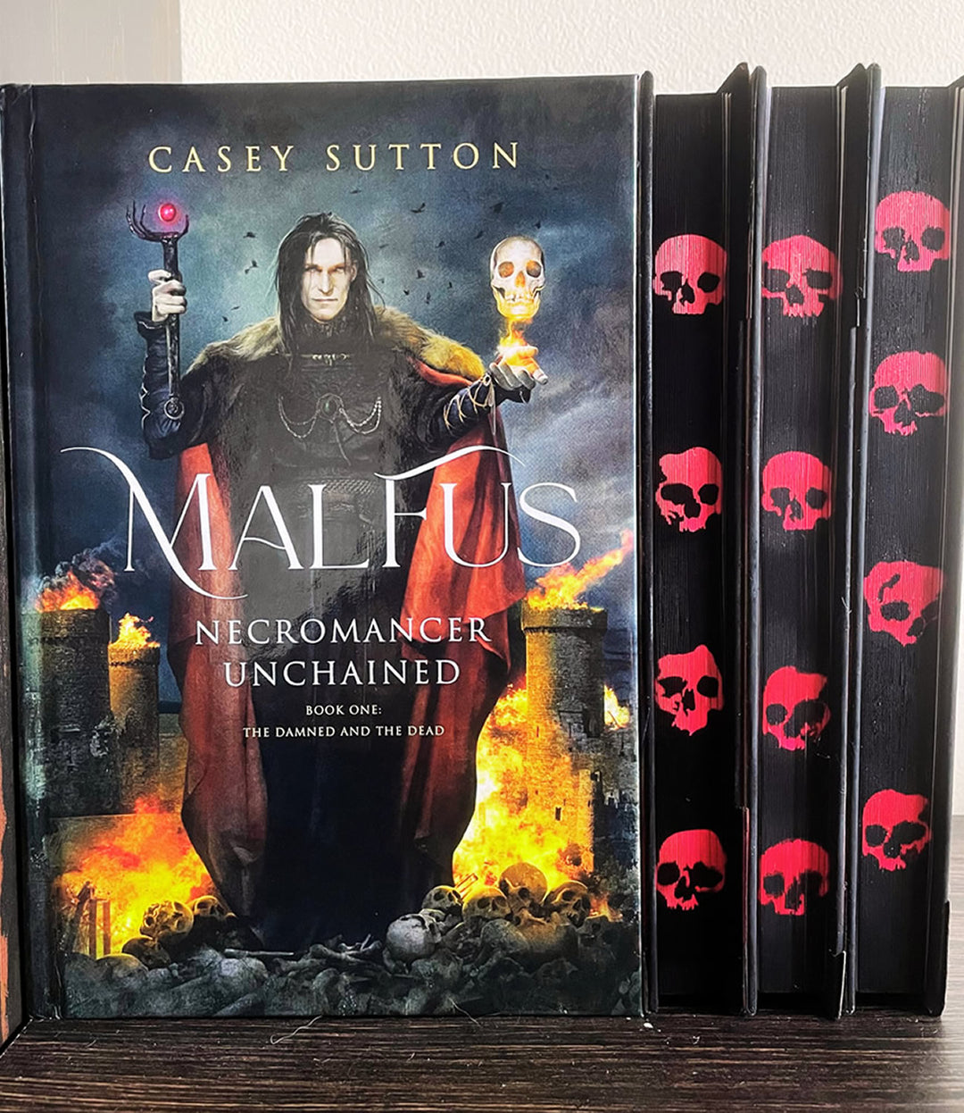 Malfus: Necromancer Unchained - SPRAYED EDGE (MUSOU Black with Red Skulls) - Signed Hardcover